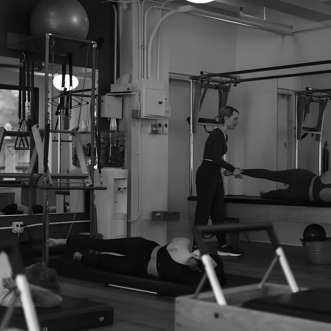 Instructor guiding prenatal Pilates