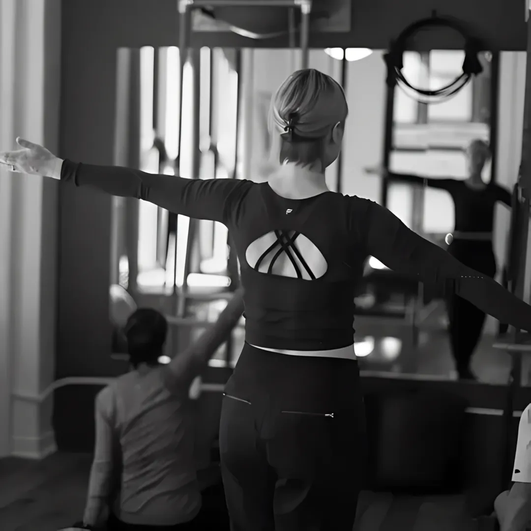 Instructor supporting gentle Pilates recovery work