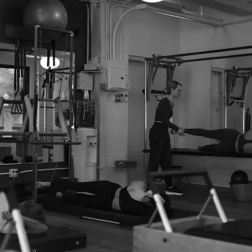 Instructor cueing a classical Pilates movement