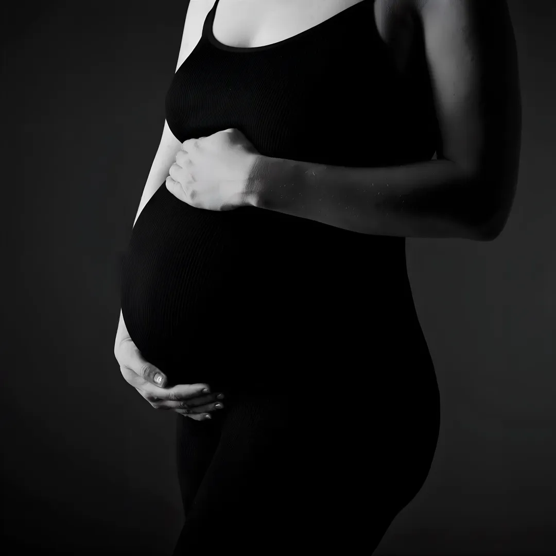 Pregnant client receiving Pilates instruction in a calm studio