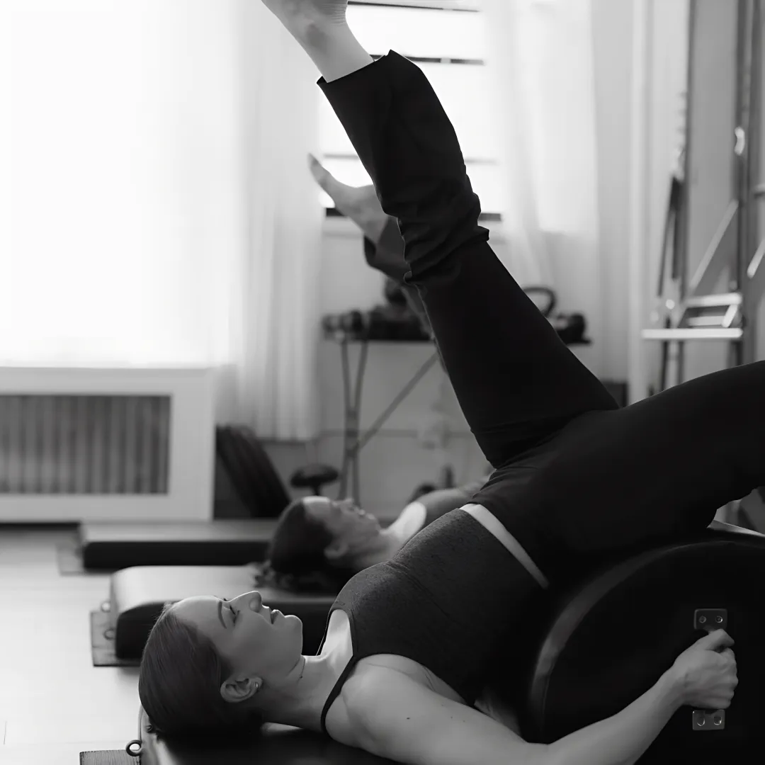 Instructor guiding Cadillac Pilates movement