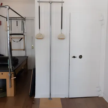Instructor guiding a Pilates reformer session