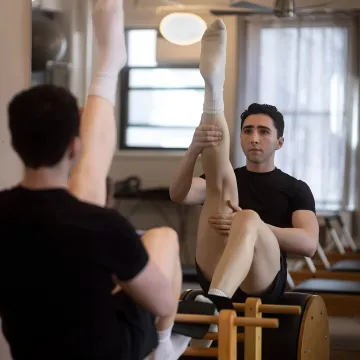 Client practicing supported Pilates rehabilitation