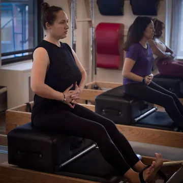 Pilates instructor guiding pelvic floor exercises
