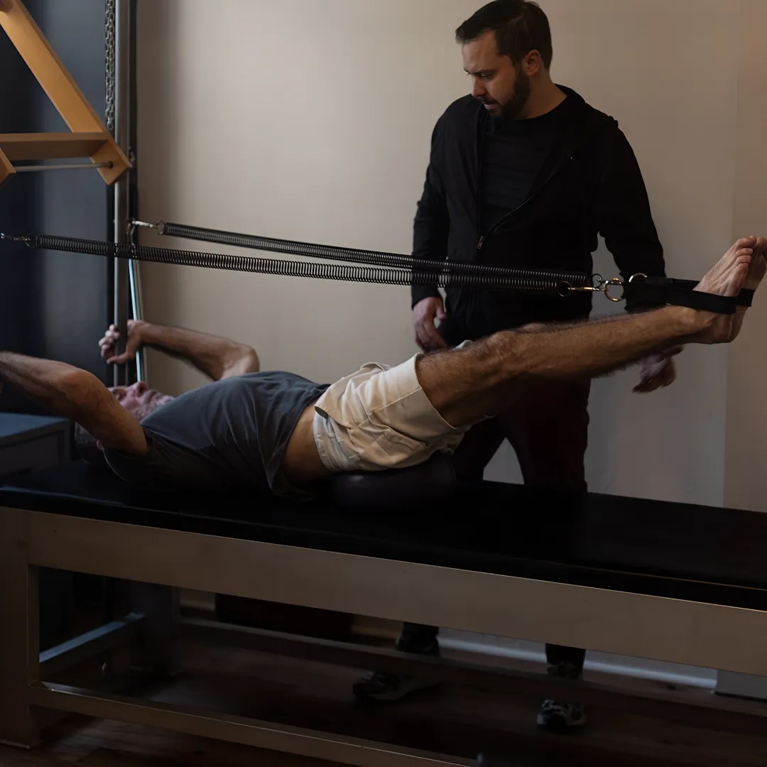 Pilates instructor guiding a rehabilitation session