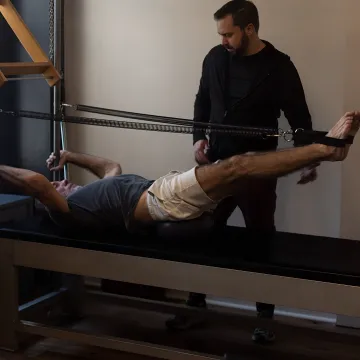 Pilates instructor guiding a rehabilitation session