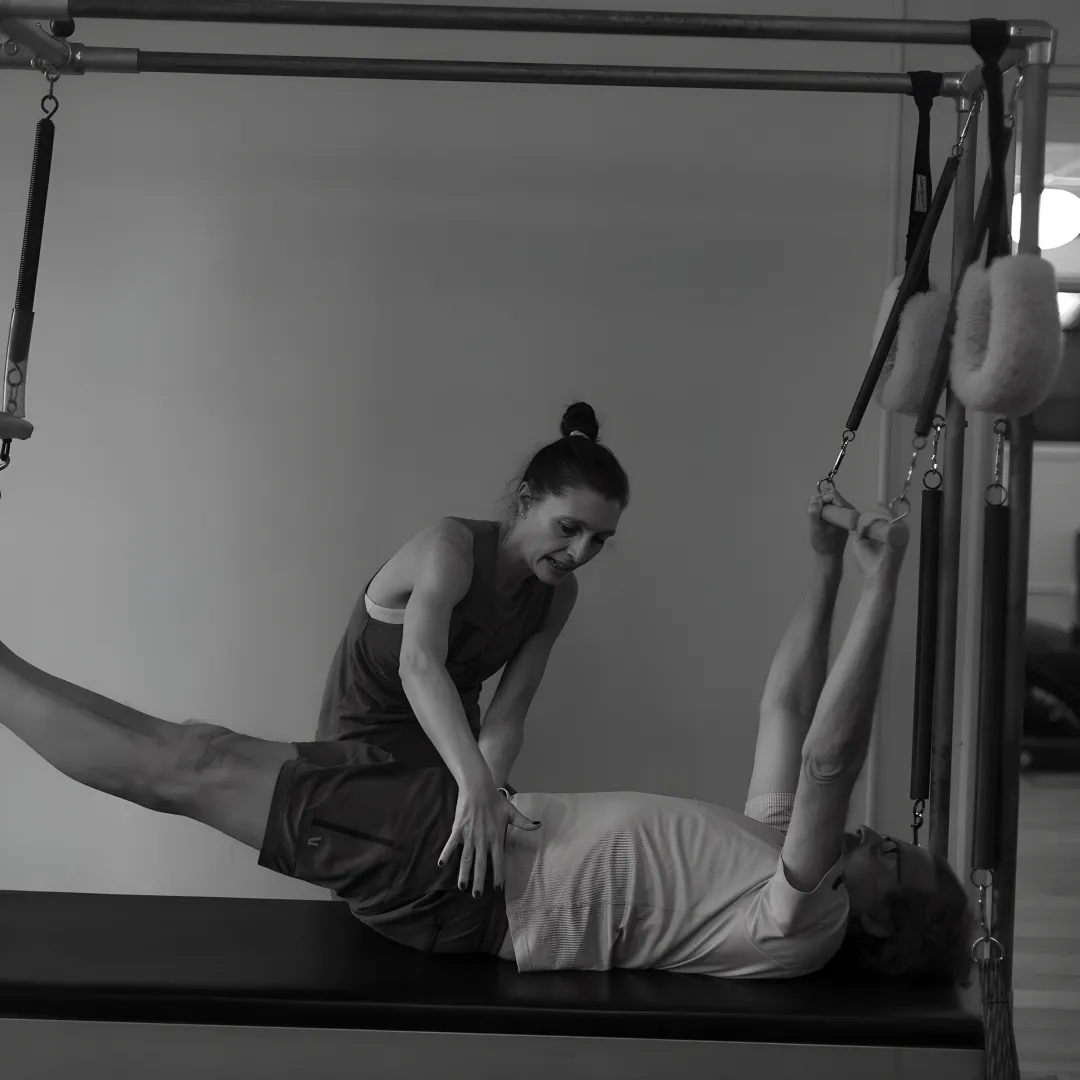 Pilates client training on a reformer in a boutique studio