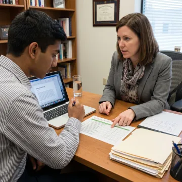 Student and counsellor reviewing study abroad applications