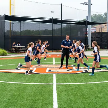 Students using a new artificial turf field