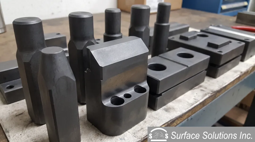Nitrided metal forming punch and die tooling showing surface finish and wear resistance