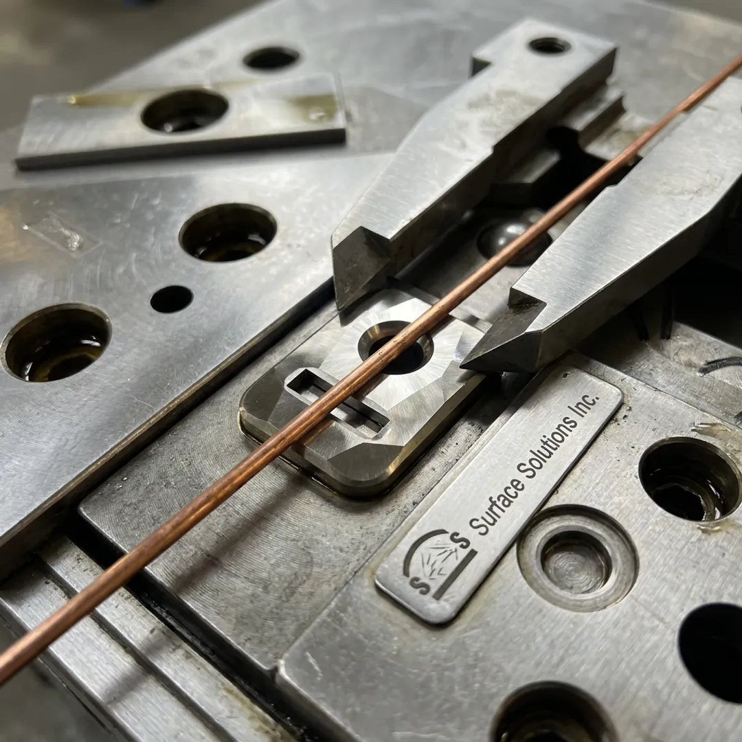 Diamond coated wire drawing dies on workbench