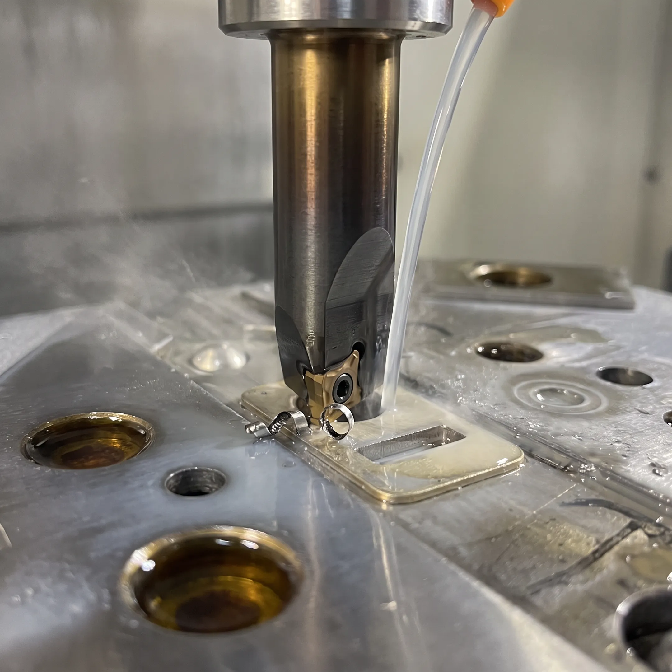 Coated boring tool machining a metal workpiece