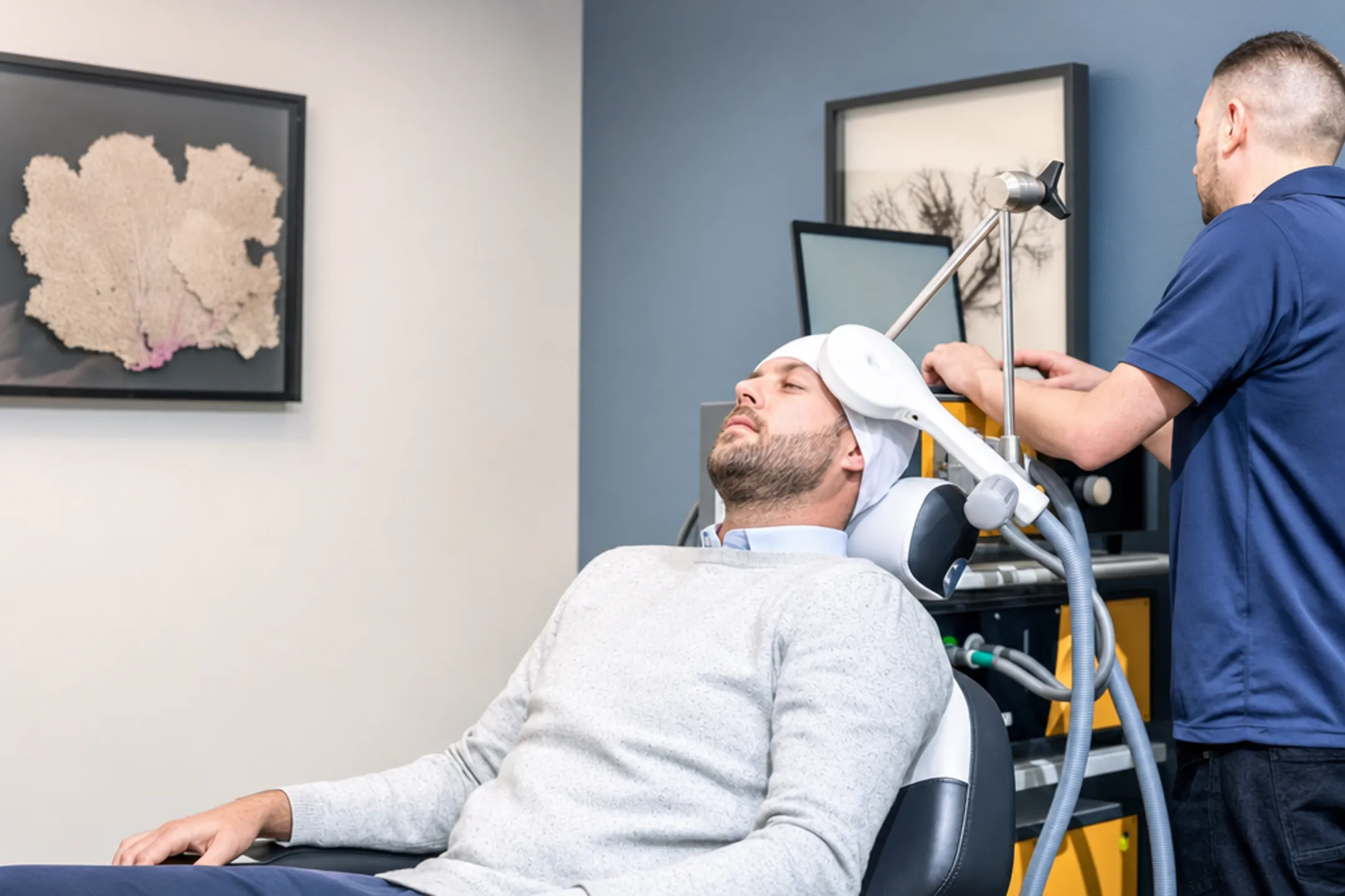 Patient receiving TMS therapy session seated comfortably in treatment chair