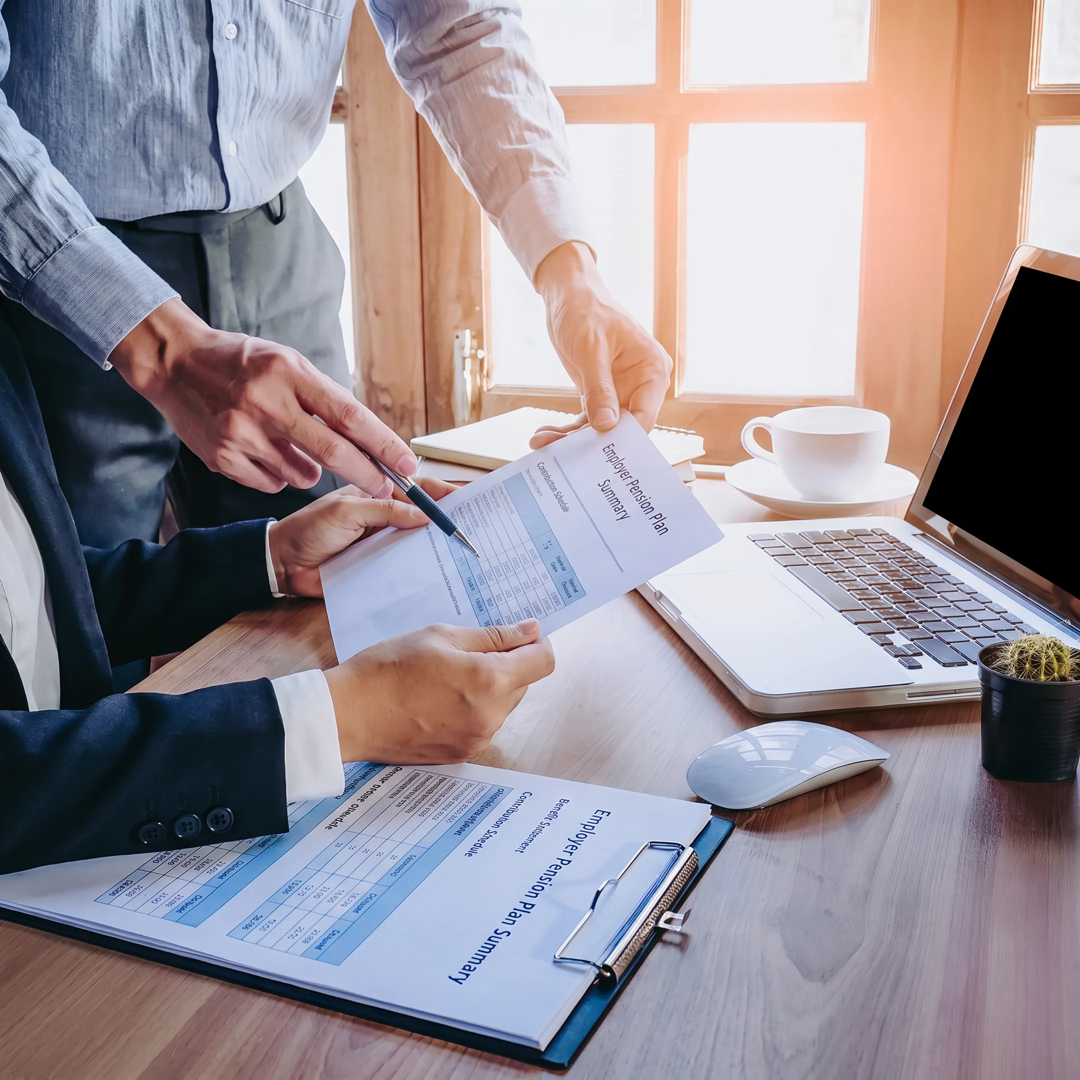 Retirement plan advisor reviewing employer pension strategy with business leaders