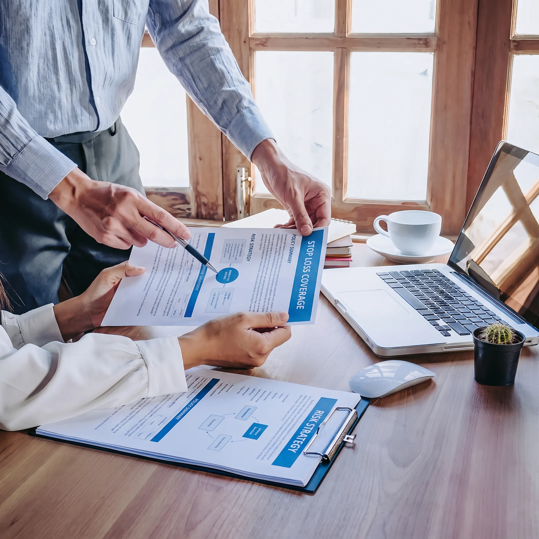 Insurance broker reviewing stop loss coverage opportunities with business benefits decision-makers