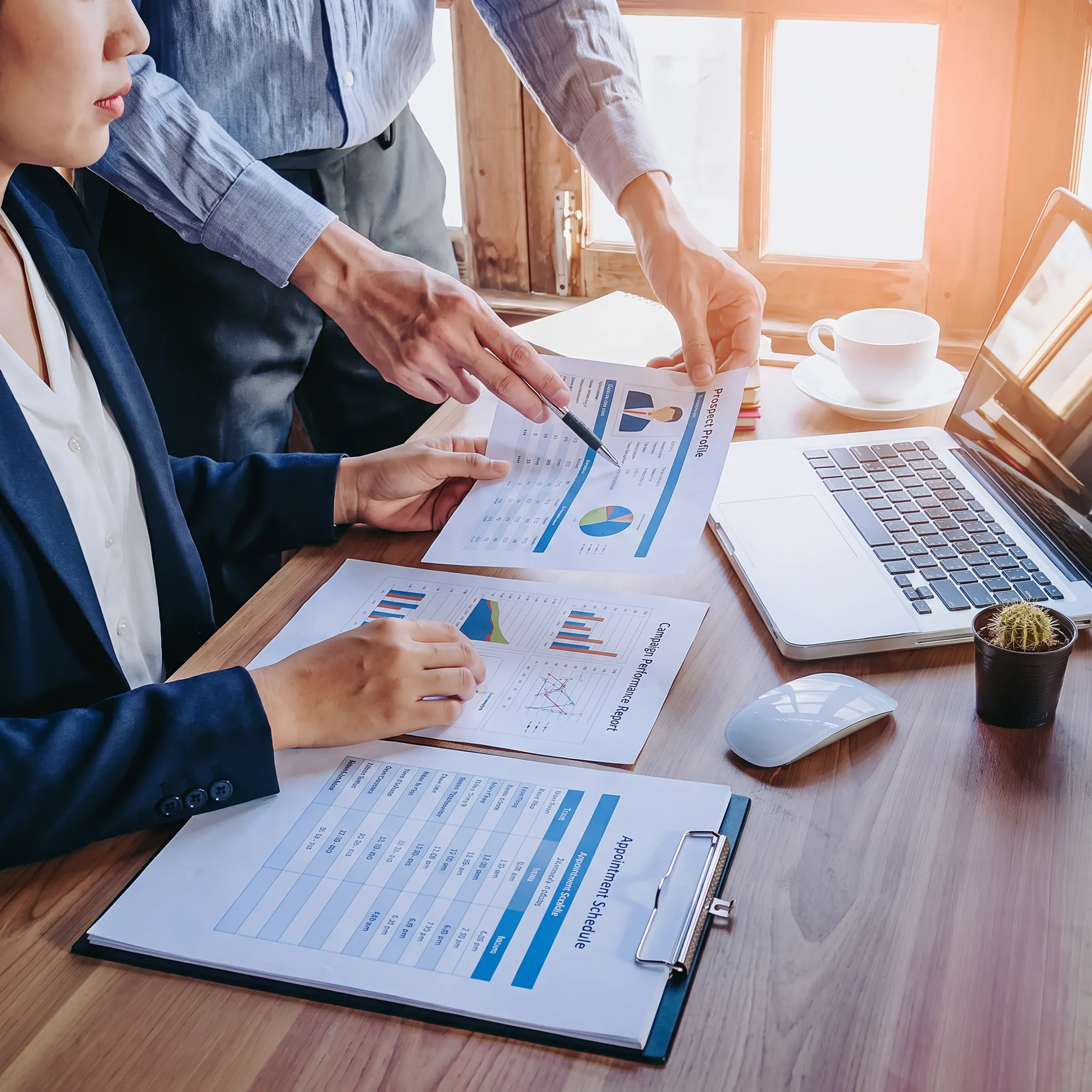 Insurance professional reviewing qualified business prospects with a sales team