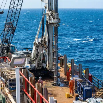 Offshore helical pile installation on marine platform with specialized equipment