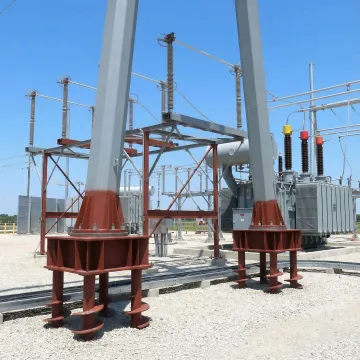 Commercial helical pier foundation system supporting industrial equipment