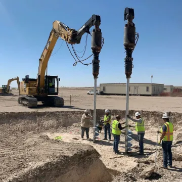 Professional helical pier installation for retaining wall foundation support