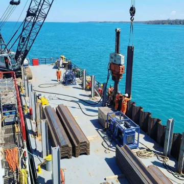 Waterside seawall repair equipment working from water side of structure