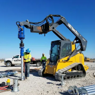 Custom helical pile foundation system installation in industrial setting