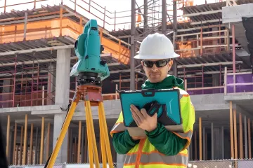 Structural engineer reviewing load calculation blueprints and foundation design plans
