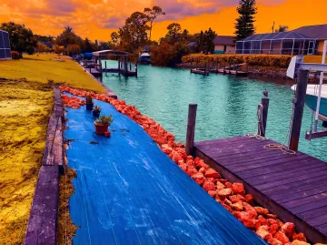 Professional seawall repair crew working on waterfront structure in Bonita Springs Florida
