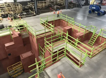 Engineering team reviewing foundation design plans at industrial construction site