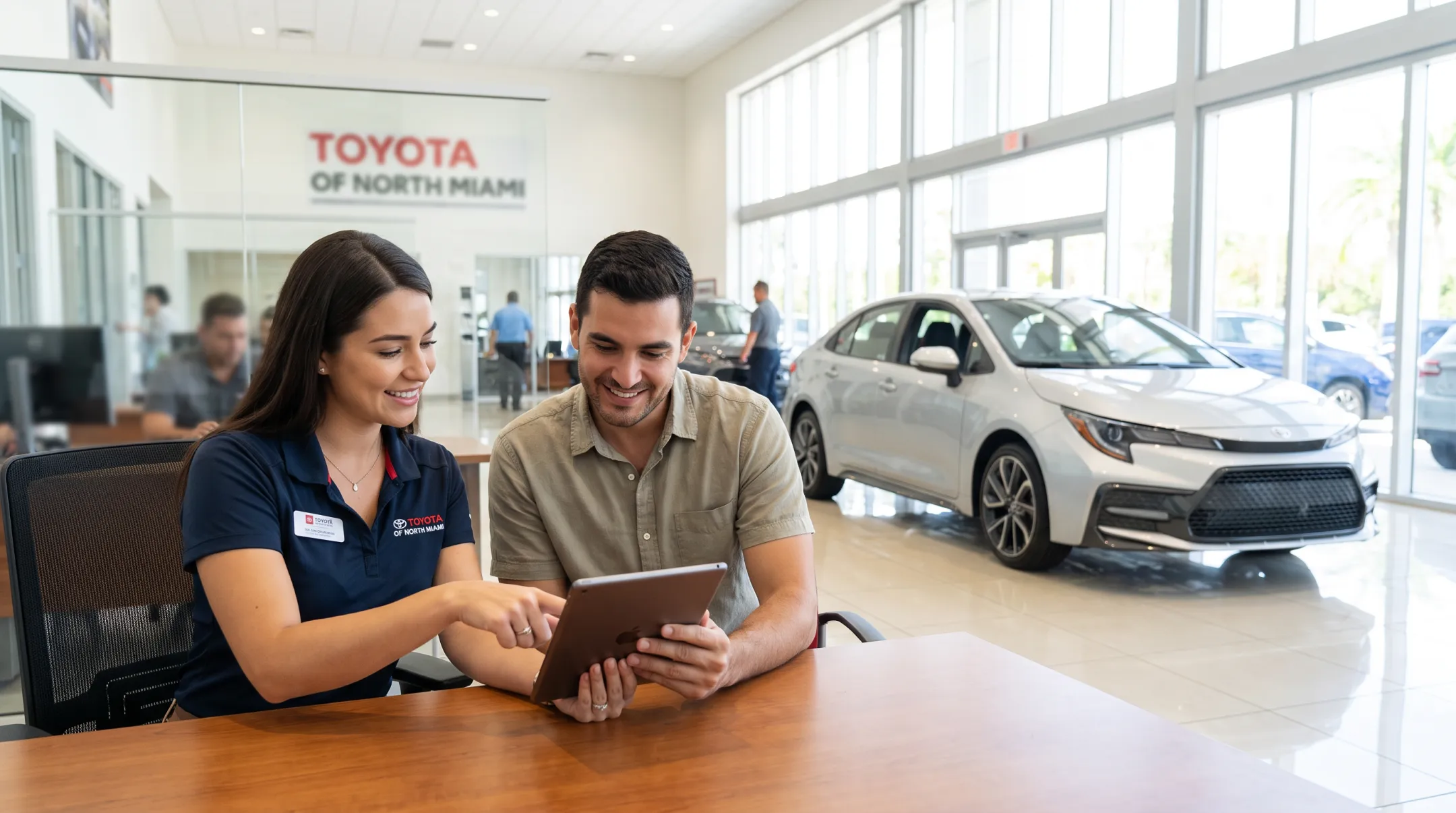 Toyota dealership consultant helping customer plan Corolla purchase online