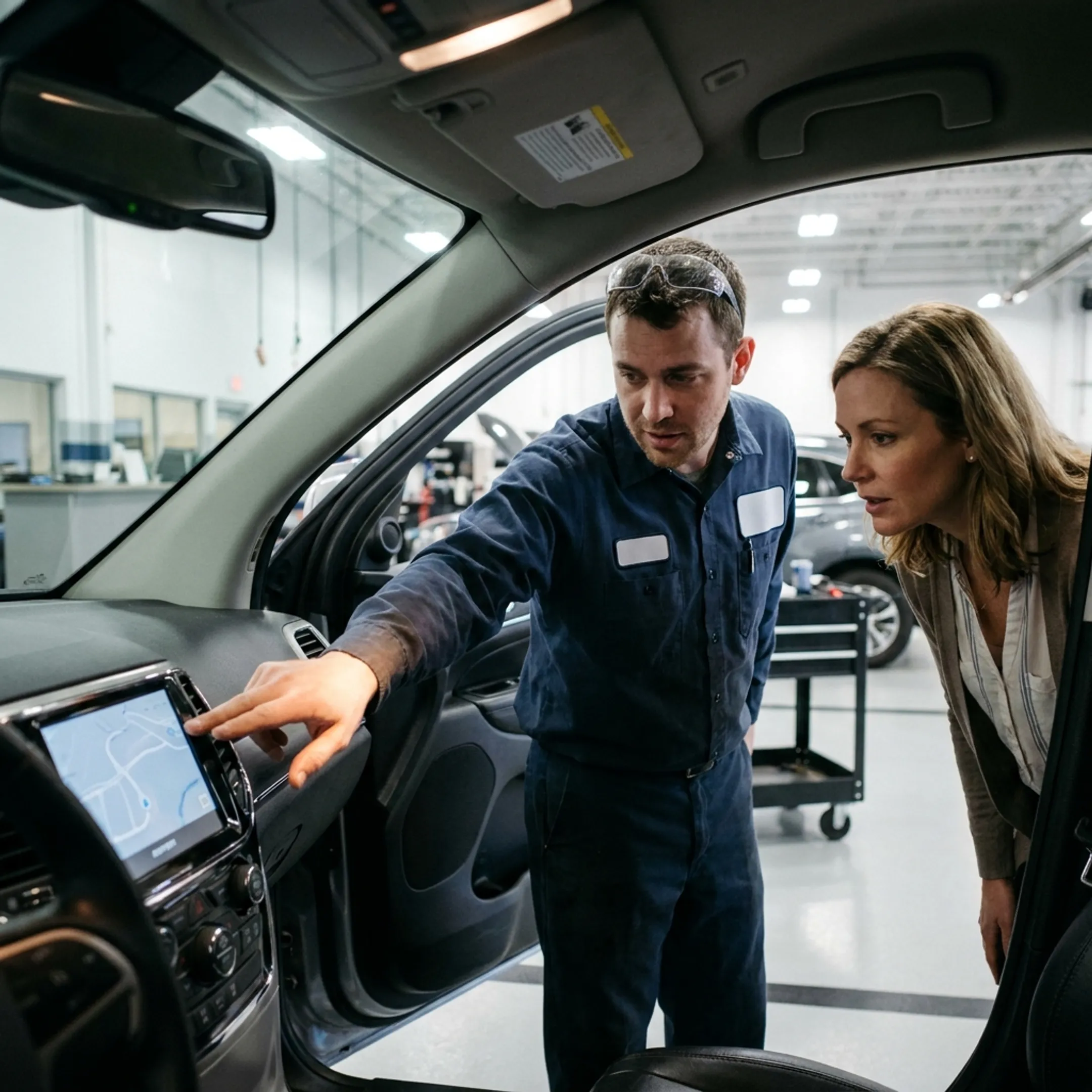 Toyota service technician reviewing a vehicle navigation screen