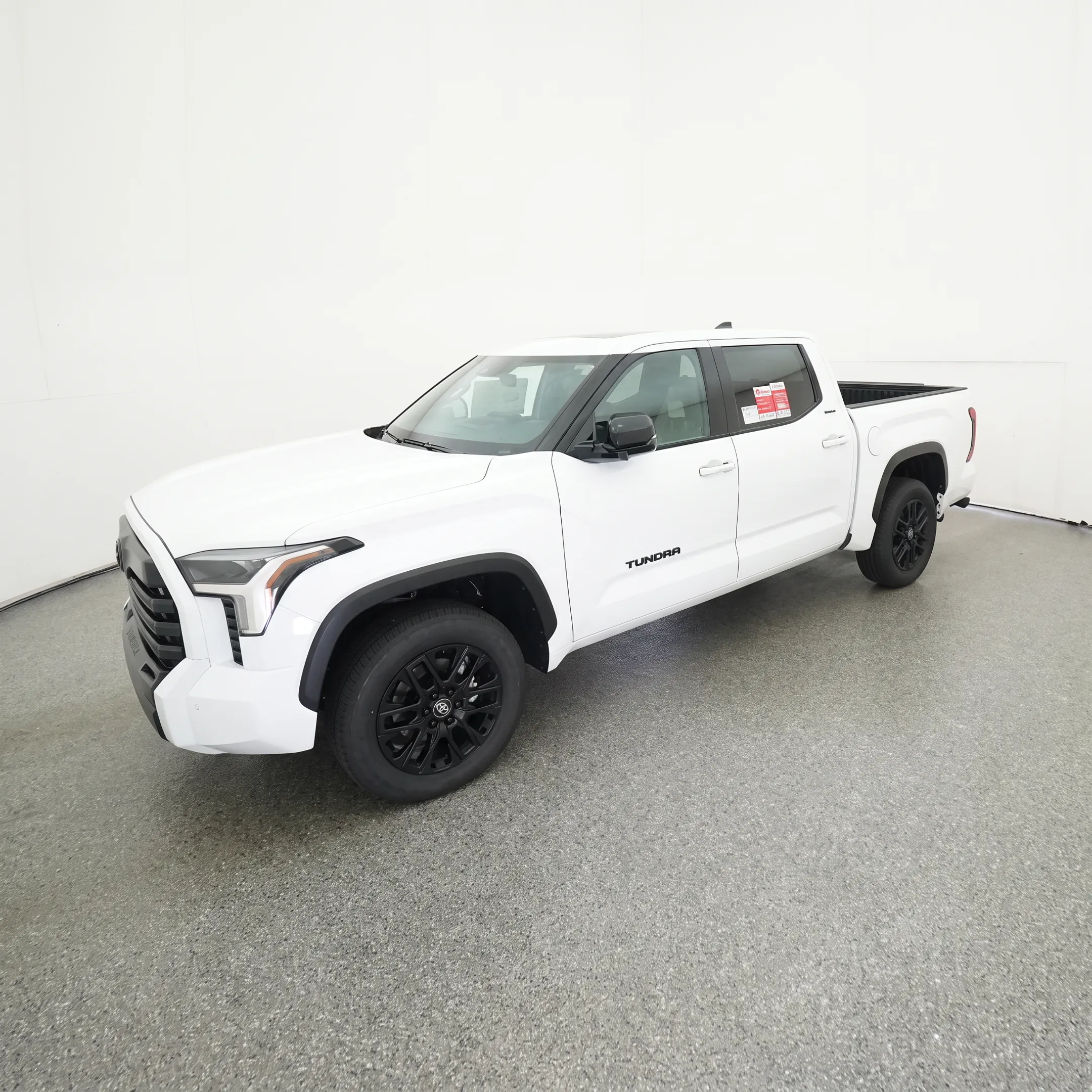 Customer reviewing a 2026 Toyota Tundra hybrid with a dealership specialist