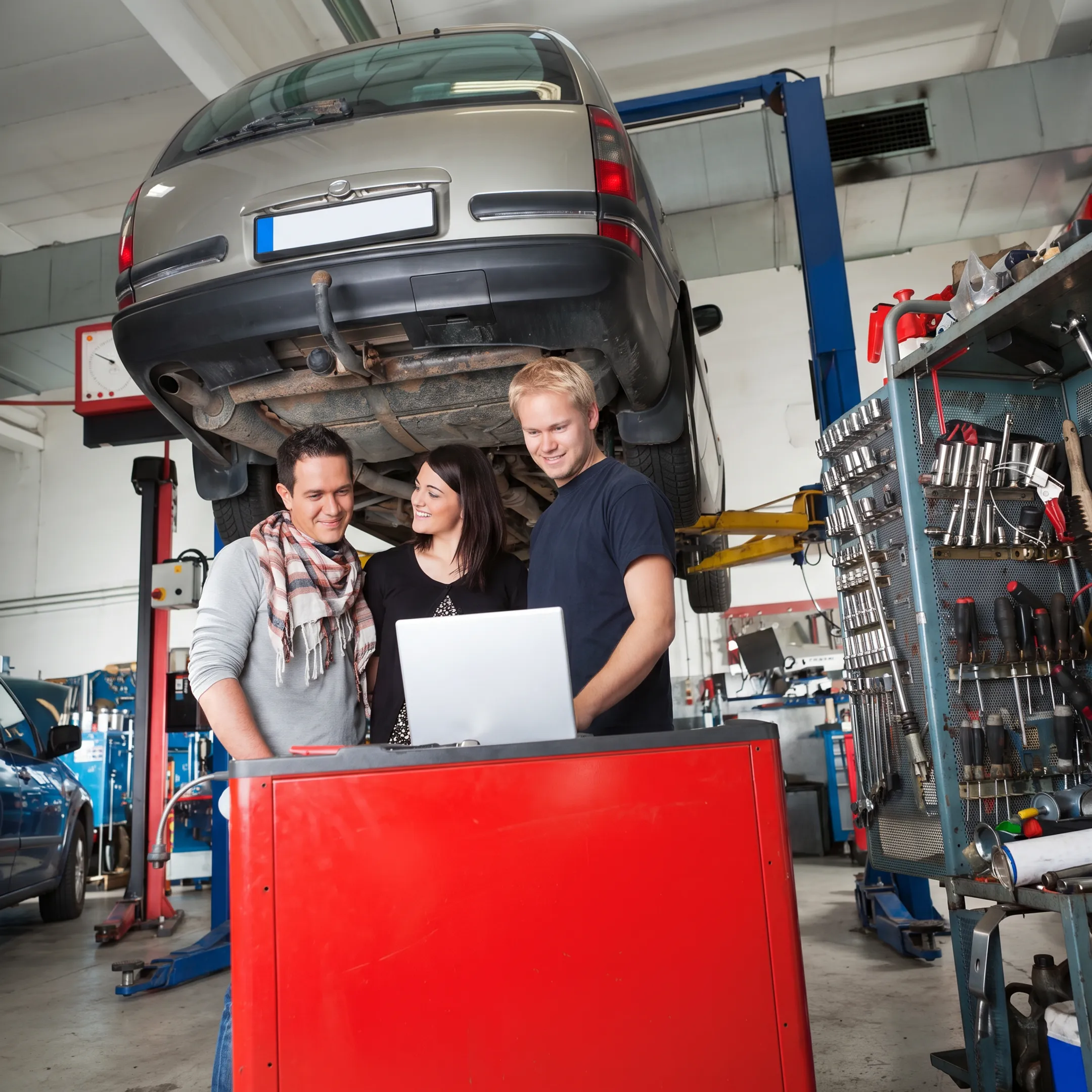 Technician performing Toyota maintenance in a dealership service bay