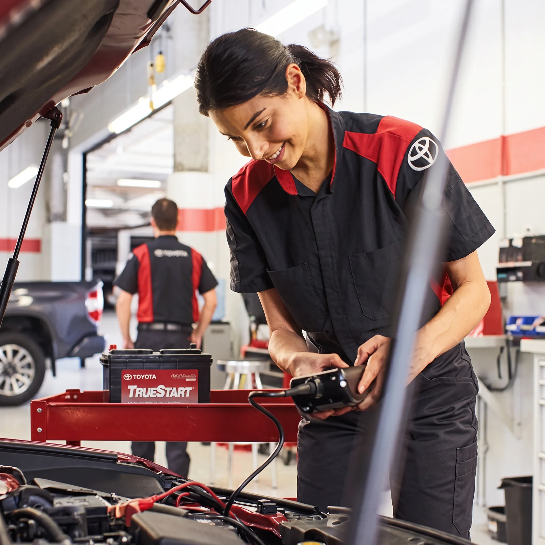 Toyota technician performing hybrid vehicle maintenance