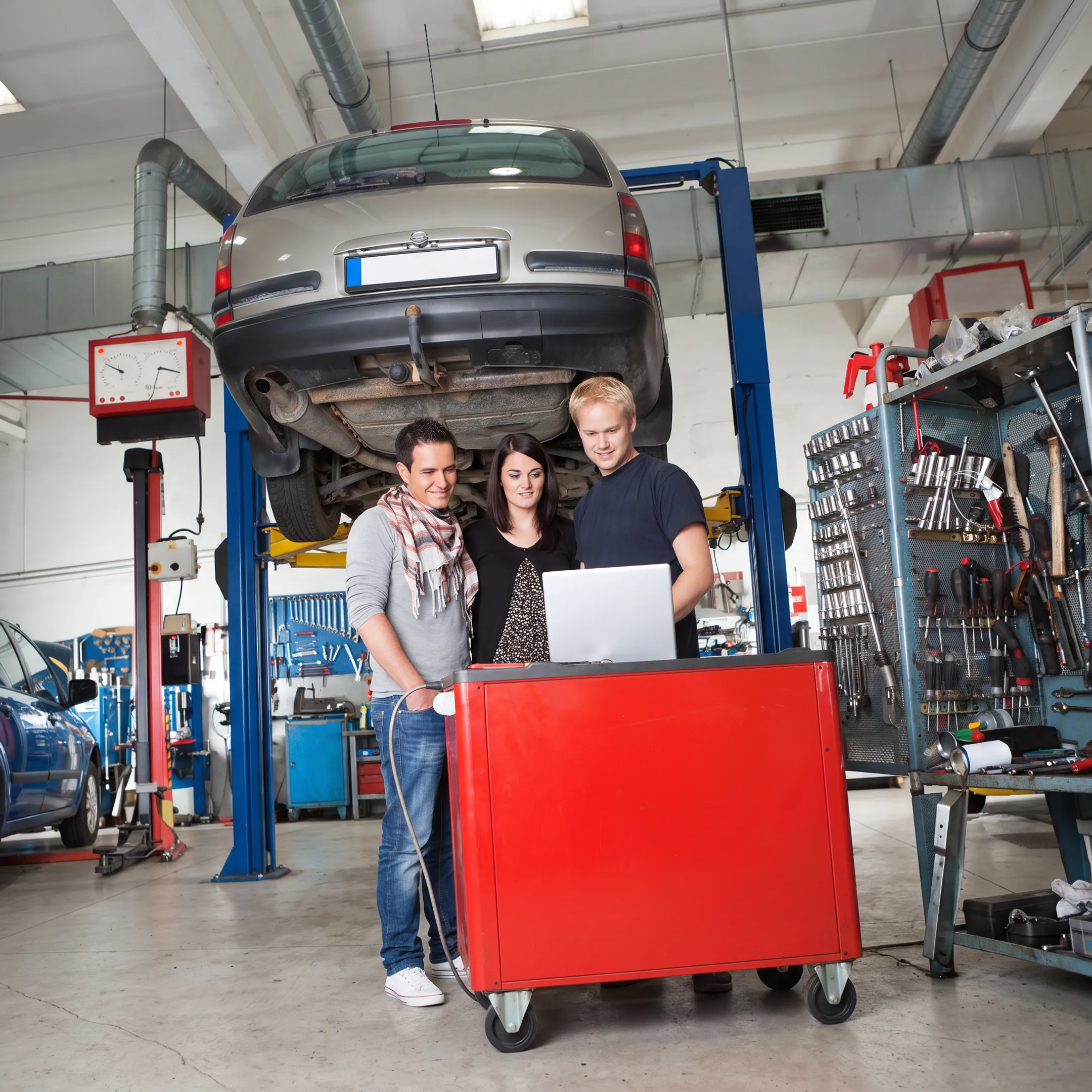 Automotive technician diagnosing a vehicle AC system