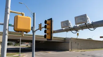 PIR traffic sensor mounted on pole detecting vehicle at signalized intersection approach