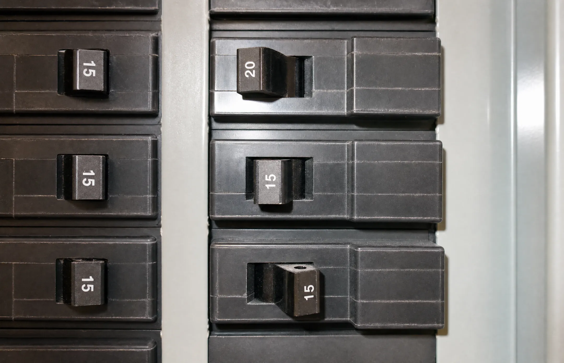 Circuit breaker panel showing tripped breaker requiring electrician inspection