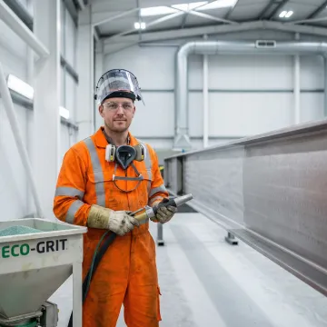 Professional eco blasting equipment preparing metal surface in Tampa Bay industrial facility