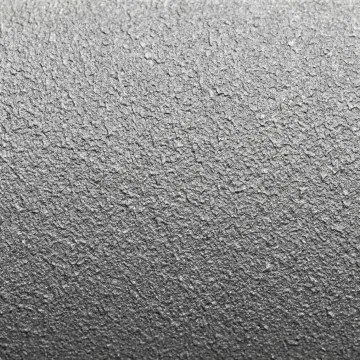 Close-up of professionally sandblasted metal surface showing uniform texture profile