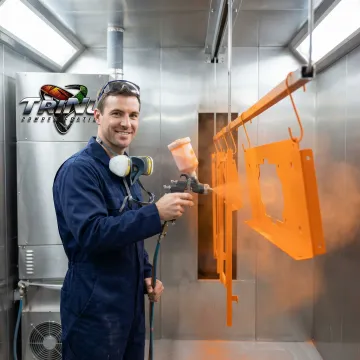 Professional powder coating application on metal parts in St. Petersburg facility