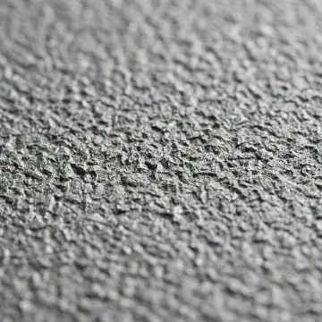 Close-up of freshly grit-blasted steel surface showing anchor profile texture