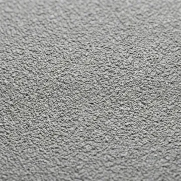 Close-up of professionally sandblasted metal surface showing uniform texture profile