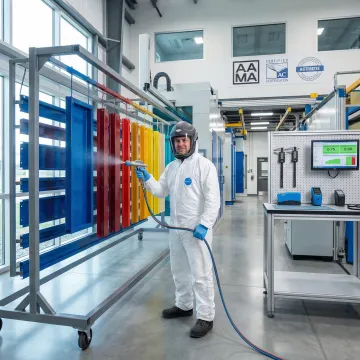 Close-up of quality-certified powder coating process on industrial metal components