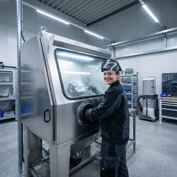 Professional glass bead blasting equipment preparing metal surface with precision