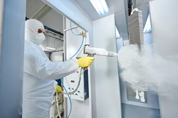 Professional powder coating application on metal component in Florida facility