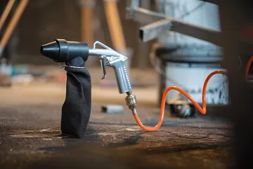 Professional eco blasting equipment preparing metal surface in Tampa Bay industrial facility