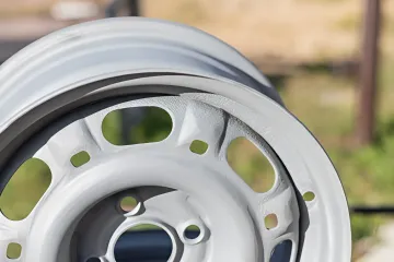 Professional automotive powder coating application on car parts in Tampa Bay facility