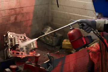 Automotive parts undergoing precision powder coating surface treatment