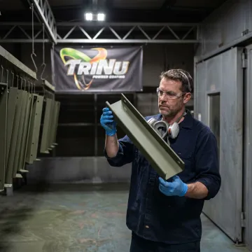 Technician inspecting mil-spec coated metal components