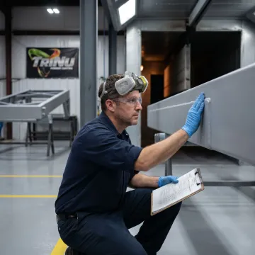 Technician inspecting coated aviation equipment parts