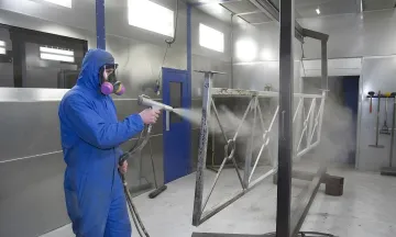 Industrial powder coating process showing surface preparation and application stages